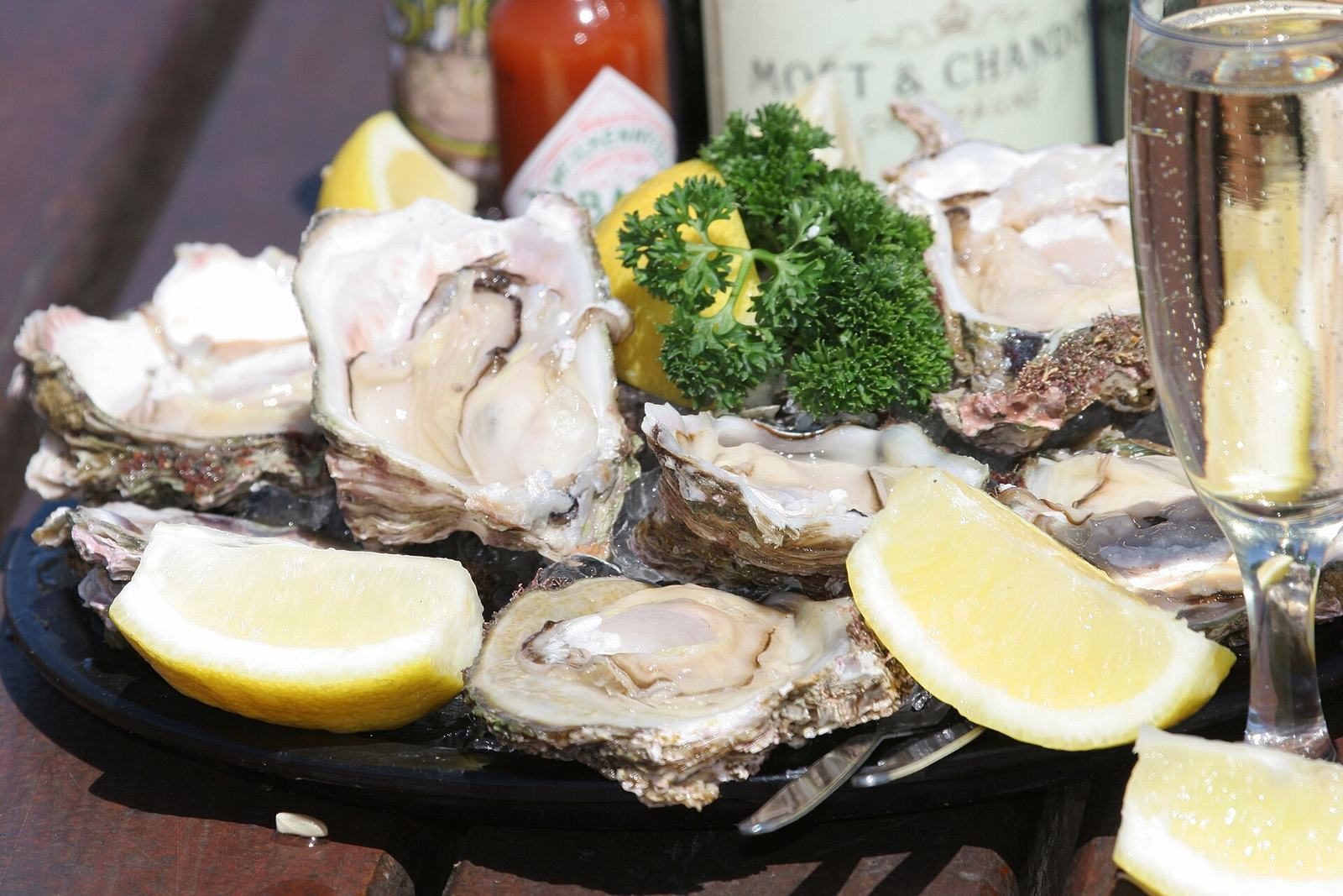 A plate of fresh oysters with lemon