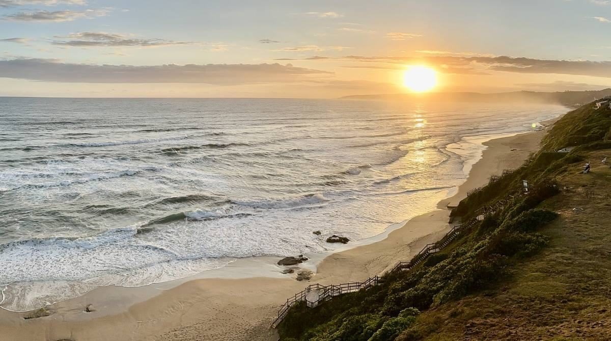 A long sandy beach at sunset on the Garden Route
